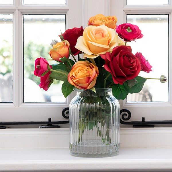 artificial foliage arranged into glass vase 